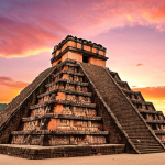 **A majestic view of the Great Plaza at Copán during sunset. Capture the warm, pink and orange tones of the sky over the stelae, with one person sitting atop a pyramid.**